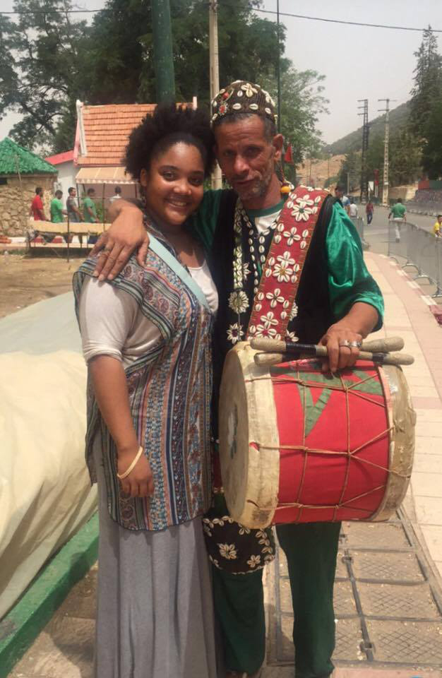 woman posing for picture with man carrying drum