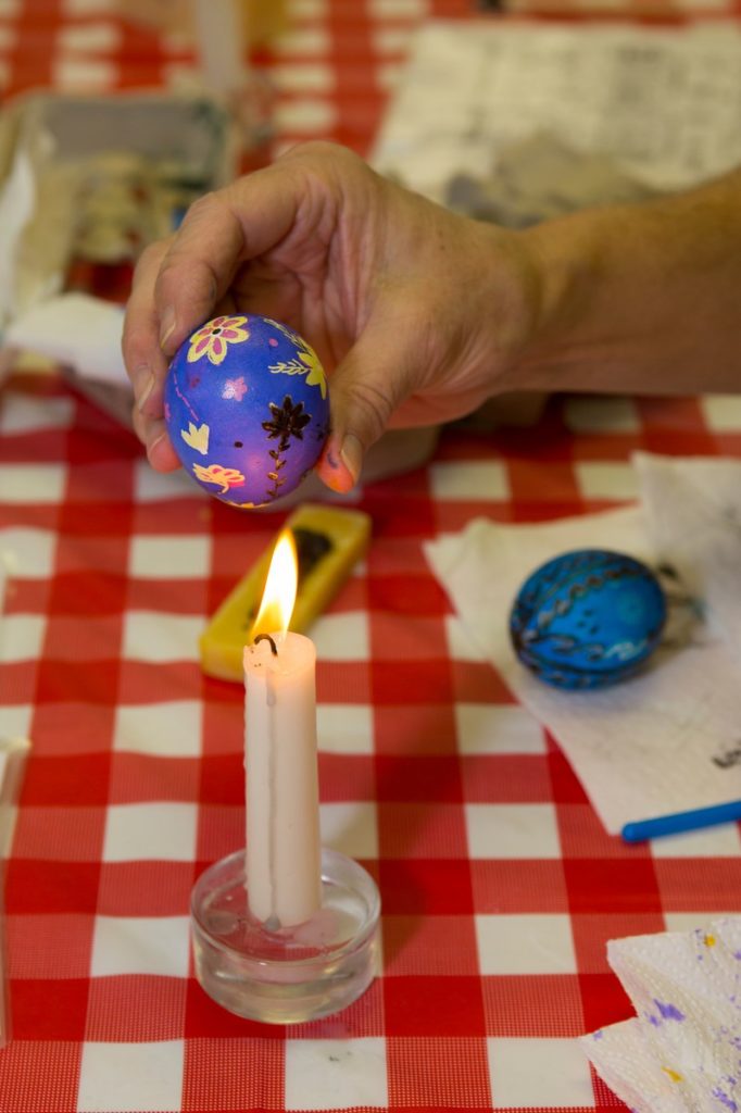Melting the wax off the egg reveals the design