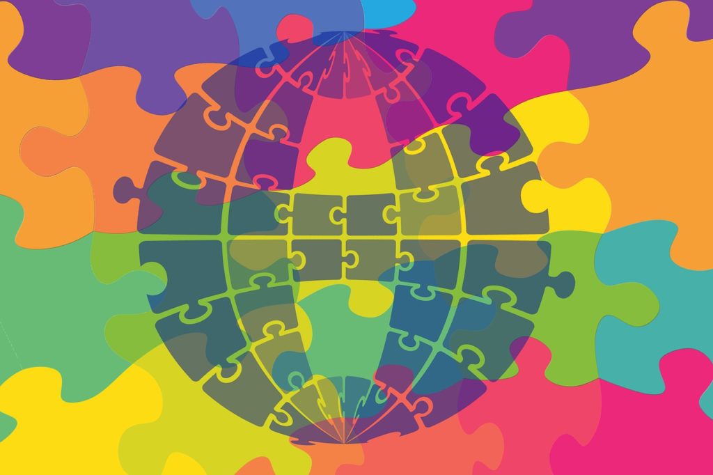 a globe made up of multicolored puzzle pieces
